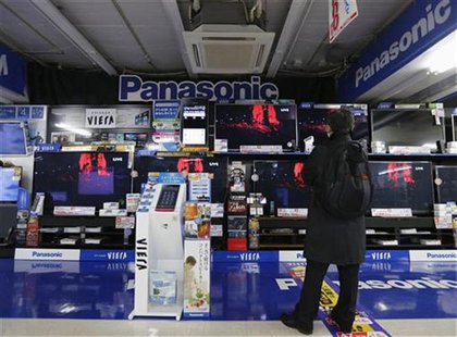 A man looks at Panasonic TV sets at an electronic shop in Tokyo November 22, 2012. Ratings agency Fitch cut the debt ratings of Japanese con A man looks at Panasonic TV sets at an electronic shop in Tokyo November 22, 2012. Ratings agency Fitch cut the debt ratings of Japanese con
