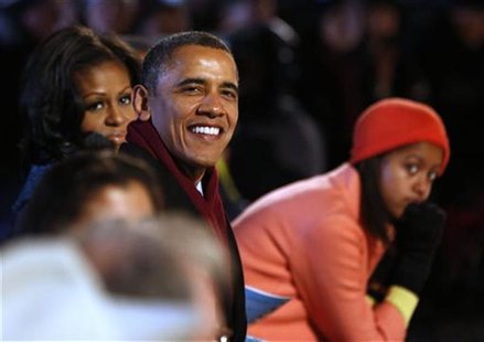 U.S. President Barack Obama (C) is joined by his daughter Malia (R) and first lady, Michelle Obama (L) as they watch the show at the officia U.S. President Barack Obama (C) is joined by his daughter Malia (R) and first lady, Michelle Obama (L) as they watch the show at the officia