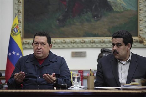 Venezuelan President Hugo Chavez speaks next to Vice President Nicolas Maduro during a national broadcast at Miraflores Palace in Caracas De Venezuelan President Hugo Chavez speaks next to Vice President Nicolas Maduro during a national broadcast at Miraflores Palace in Caracas De