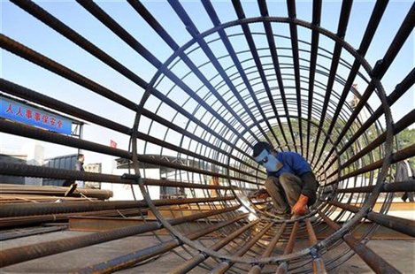A worker welds steel bars at a construction site for a new train station in Ningbo, Zhejiang province, December 6, 2012. REUTERS/China Daily A worker welds steel bars at a construction site for a new train station in Ningbo, Zhejiang province, December 6, 2012. REUTERS/China Daily