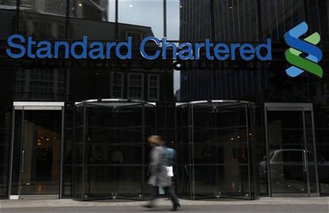A woman walks past a Standard Chartered bank in London October 13, 2010. REUTERS/Stefan Wermuth A woman walks past a Standard Chartered bank in London October 13, 2010. REUTERS/Stefan Wermuth