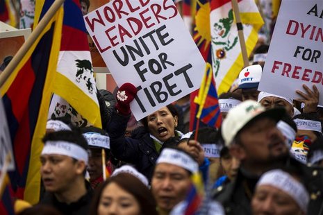 Protesters chant and hold placards as they take part in a solidarity march from the Chinese Consulate to the United Nations (UN) Headquarter Protesters chant and hold placards as they take part in a solidarity march from the Chinese Consulate to the United Nations (UN) Headquarter