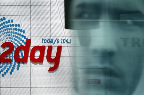 Advertisement is reflected at the entrance of the building that houses the 2Day FM radio station in Sydney December 8, 2012. REUTERS/Daniel Advertisement is reflected at the entrance of the building that houses the 2Day FM radio station in Sydney December 8, 2012. REUTERS/Daniel