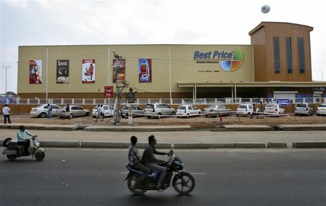 Two-wheelers move past the newly opened Bharti Wal-Mart Best Price Modern wholesale store in the southern Indian city of Hyderabad September Two-wheelers move past the newly opened Bharti Wal-Mart Best Price Modern wholesale store in the southern Indian city of Hyderabad September