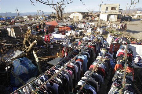 Residents hang clothes they are selling to dry under the sun in the coastal town of Cateel that was devastated during last Tuesday's Typhoon Residents hang clothes they are selling to dry under the sun in the coastal town of Cateel that was devastated during last Tuesday's Typhoon