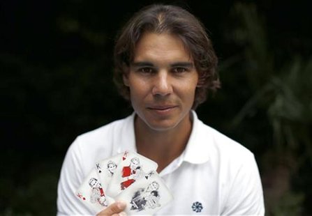 Spanish tennis player Rafa Nadal poses with playing cards depicting some of his 11 Grand Slam victories after an interview with Reuters in M Spanish tennis player Rafa Nadal poses with playing cards depicting some of his 11 Grand Slam victories after an interview with Reuters in M