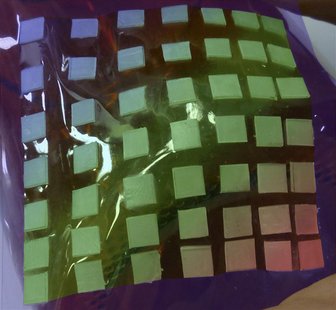 A stretchable material containing squared stiff islands for the protection of brittle electronic devices is pictured in this handout photo. A stretchable material containing squared stiff islands for the protection of brittle electronic devices is pictured in this handout photo.