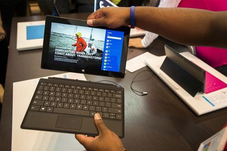 Sales staff demonstrate the Microsoft Surface during the opening of Microsoft's retail store in New York's Times Square October 25, 2012. RE Sales staff demonstrate the Microsoft Surface during the opening of Microsoft's retail store in New York's Times Square October 25, 2012. RE