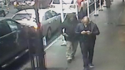 A gunman is seen pulling a weapon behind Brandon Lincoln Woodard (R) a moment before Woodward was shot in Manhattan, in this image taken fro A gunman is seen pulling a weapon behind Brandon Lincoln Woodard (R) a moment before Woodward was shot in Manhattan, in this image taken fro