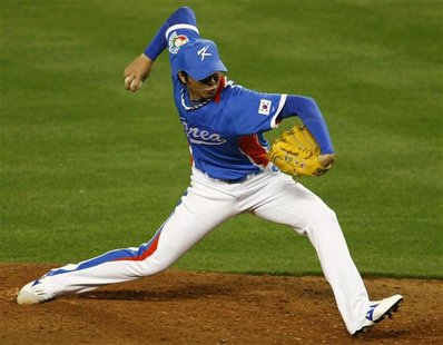 Team Korea's closing pitcher Lim Chang Yong throws against Team Venezuela in the ninth inning during the semifinal game at the World Basebal Team Korea's closing pitcher Lim Chang Yong throws against Team Venezuela in the ninth inning during the semifinal game at the World Basebal