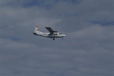 An airplane belonging to China's state oceanic administration flies past about 15 km (9 miles) south of one of the disputed islets, known as An airplane belonging to China's state oceanic administration flies past about 15 km (9 miles) south of one of the disputed islets, known as