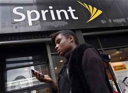 A woman uses her phone as she walks past a Sprint store in New York's financial district, October 15, 2012. REUTERS/Brendan McDermid A woman uses her phone as she walks past a Sprint store in New York's financial district, October 15, 2012. REUTERS/Brendan McDermid