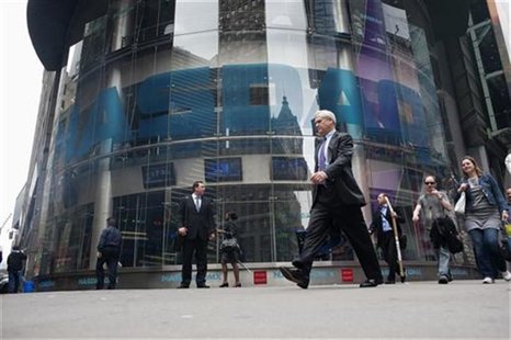 Commuters walk past the NASDAQ MarketSite in New York's Times Square May 22, 2012. REUTERS/Keith Bedford Commuters walk past the NASDAQ MarketSite in New York's Times Square May 22, 2012. REUTERS/Keith Bedford