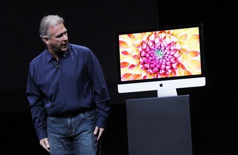 Apple senior vice president of worldwide marketing Philip Schiller displays a new model of the iMac desktop computer during an Apple event i Apple senior vice president of worldwide marketing Philip Schiller displays a new model of the iMac desktop computer during an Apple event i