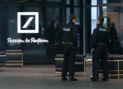 Police officers stand inside the lobby of the headquarters of Germany's largest business bank, Deutsche Bank AG in Frankfurt December 12, 20 Police officers stand inside the lobby of the headquarters of Germany's largest business bank, Deutsche Bank AG in Frankfurt December 12, 20