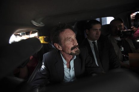 Software pioneer John McAfee is escorted by immigration officers at La Aurora International Airport in Guatemala City December 12, 2012. REU Software pioneer John McAfee is escorted by immigration officers at La Aurora International Airport in Guatemala City December 12, 2012. REU