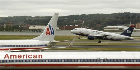 A US Airways plane takes off behind an American Airlines jet at Ronald Reagan National Airport in Washington April 23, 2012. REUTERS/Kevin L A US Airways plane takes off behind an American Airlines jet at Ronald Reagan National Airport in Washington April 23, 2012. REUTERS/Kevin L