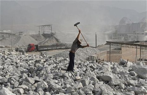 A worker smashes limestone inside a limestone mine in Quzhou, Zhejiang province October 12, 2012. REUTERS/Stringer A worker smashes limestone inside a limestone mine in Quzhou, Zhejiang province October 12, 2012. REUTERS/Stringer
