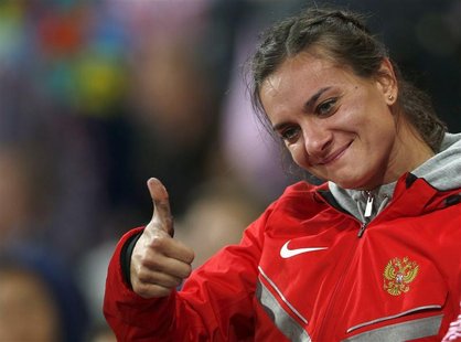 Russia's Yelena Isinbayeva gives a thumbs-up after winning bronze in the women's pole vault final during the London 2012 Olympic Games at th Russia's Yelena Isinbayeva gives a thumbs-up after winning bronze in the women's pole vault final during the London 2012 Olympic Games at th