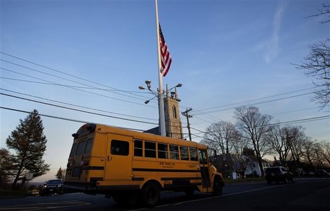 A flag is seen at half mast as a school bus passes along Main Street in Newtown, Connecticut December 14, 2012. REUTERS/Shannon Stapleton A flag is seen at half mast as a school bus passes along Main Street in Newtown, Connecticut December 14, 2012. REUTERS/Shannon Stapleton