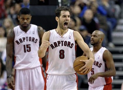 Toronto Raptors guard Jose Calderon (C) reacts in front of teammates Amir Johnson (L) and John Lucas III after drawing a penalty to the Hous Toronto Raptors guard Jose Calderon (C) reacts in front of teammates Amir Johnson (L) and John Lucas III after drawing a penalty to the Hous
