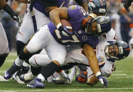 Baltimore Ravens running back Ray Rice (L) is tackled by Denver Broncos linebacker Keith Brooking (R) during the first half of their NFL foo Baltimore Ravens running back Ray Rice (L) is tackled by Denver Broncos linebacker Keith Brooking (R) during the first half of their NFL foo