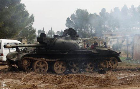 A damaged tank is seen after Free Syrian Army fighters captured the Military Infantry School following heavy clashes with forces loyal to Pr A damaged tank is seen after Free Syrian Army fighters captured the Military Infantry School following heavy clashes with forces loyal to Pr