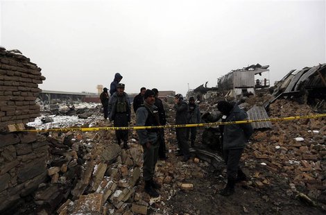 Afghan policemen stand at the site of a blast in Kabul December 17, 2012. REUTERS/Mohammad Ismail Afghan policemen stand at the site of a blast in Kabul December 17, 2012. REUTERS/Mohammad Ismail
