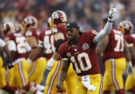 Washington Redskins starting quarterback Robert Griffin III waves to the crowd during pre-game introductions before playing the Baltimore Ra Washington Redskins starting quarterback Robert Griffin III waves to the crowd during pre-game introductions before playing the Baltimore Ra