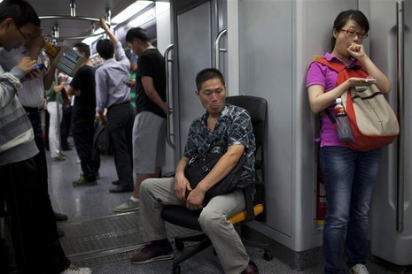 A man sits on an office chair while riding the subway train in Shanghai in this September 20, 2012 file photo. REUTERS/Aly Song/Files A man sits on an office chair while riding the subway train in Shanghai in this September 20, 2012 file photo. REUTERS/Aly Song/Files