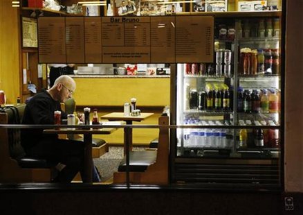A man sits in a cafe in London November 13, 2012. REUTERS/Luke MacGregor A man sits in a cafe in London November 13, 2012. REUTERS/Luke MacGregor