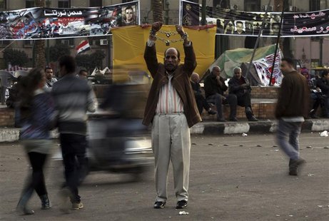 A man holds up chained hands as he protests against Egypt's President Mohamed Mursi at Tahrir Square in Cairo December 17, 2012. REUTERS/Amr A man holds up chained hands as he protests against Egypt's President Mohamed Mursi at Tahrir Square in Cairo December 17, 2012. REUTERS/Amr