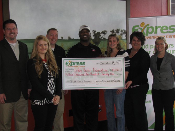 LeRoy Butler accepts the $15,221 check on behalf of his foundation to help these women in need.