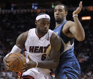 Miami Heat's LeBron James (L) drives against Minnesota Timberwolves' Kevin Love in the first half of their NBA basketball game in Miami, Flo Miami Heat's LeBron James (L) drives against Minnesota Timberwolves' Kevin Love in the first half of their NBA basketball game in Miami, Flo