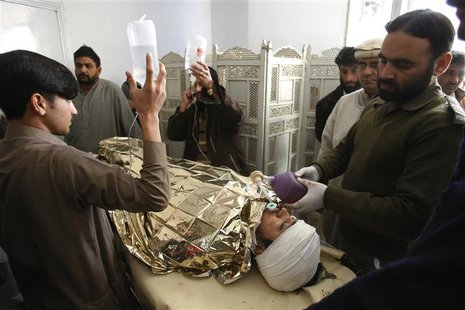 An anti-polio drive campaign worker, Hilal Khan (C), who was shot and badly injured by unidentified gunmen, lies at Lady Reading Hospital in An anti-polio drive campaign worker, Hilal Khan (C), who was shot and badly injured by unidentified gunmen, lies at Lady Reading Hospital in