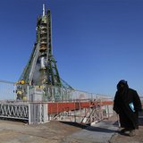 A security guard stands in front of the Soyuz TMA-07M spacecraft set on its launch pad before the blast off with the International Space Sta A security guard stands in front of the Soyuz TMA-07M spacecraft set on its launch pad before the blast off with the International Space Sta