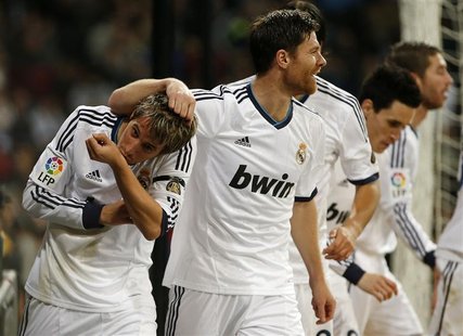 Real Madrid's Fabio Coentrao (L) celebrates his goal with his teammates during their Spanish First Division soccer match against Espanyol at Real Madrid's Fabio Coentrao (L) celebrates his goal with his teammates during their Spanish First Division soccer match against Espanyol at
