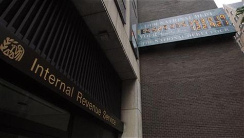 The National Debt Clock, which displays the current United States gross national debt and each American family's share, hangs on a wall next The National Debt Clock, which displays the current United States gross national debt and each American family's share, hangs on a wall next