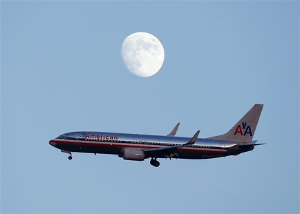 An American Airlines passenger jet glides in under the moon as it lands at LaGuardia airport in New YorkNew York, August 28, 2012. REUTERS/E An American Airlines passenger jet glides in under the moon as it lands at LaGuardia airport in New YorkNew York, August 28, 2012. REUTERS/E