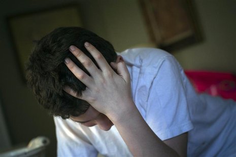 Matthew Kolen, who was diagnosed at age eight with Asperger's syndrome, puts his hand over his head while doing his homework in Long Island, Matthew Kolen, who was diagnosed at age eight with Asperger's syndrome, puts his hand over his head while doing his homework in Long Island,
