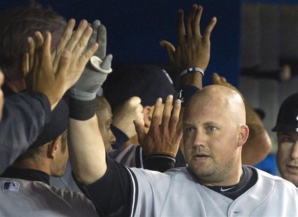 New York Yankees Casey McGehee (R) is congratulated in the dugout after he hit a three run home run against the Toronto Blue Jays in the fou New York Yankees Casey McGehee (R) is congratulated in the dugout after he hit a three run home run against the Toronto Blue Jays in the fou