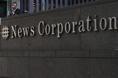 A passer-by stands in front of the News Corporation building in New York June 28, 2012. REUTERS/Keith Bedford A passer-by stands in front of the News Corporation building in New York June 28, 2012. REUTERS/Keith Bedford