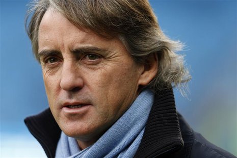Manchester City manager Roberto Mancini walks onto the pitch before their English Premier League soccer match against Manchester United at T Manchester City manager Roberto Mancini walks onto the pitch before their English Premier League soccer match against Manchester United at T