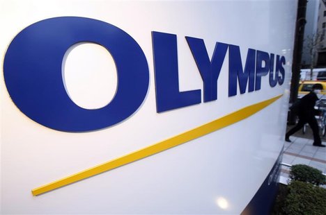 A man passes a logo of Japan's Olympus Corp outside the company showroom in Tokyo December 21, 2012. REUTERS/Yuriko Nakao A man passes a logo of Japan's Olympus Corp outside the company showroom in Tokyo December 21, 2012. REUTERS/Yuriko Nakao