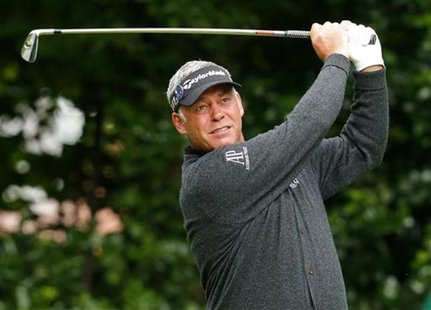 Darren Clarke of Northern Ireland watches his tee shot on the first hole during the first round of the British Open golf championship at Roy Darren Clarke of Northern Ireland watches his tee shot on the first hole during the first round of the British Open golf championship at Roy
