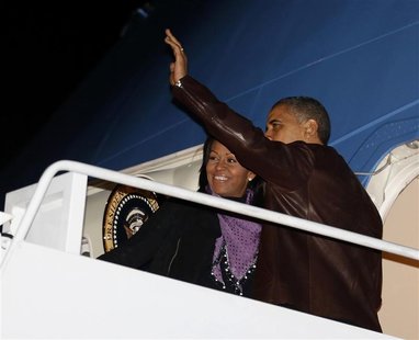 U.S. President Barack Obama waves next to first lady Michelle Obama as they prepare to depart Joint Base Andrews outside Washington, for the U.S. President Barack Obama waves next to first lady Michelle Obama as they prepare to depart Joint Base Andrews outside Washington, for the
