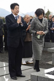 Japan's incoming Prime Minister and the leader of Liberal Democratic Party (LDP) Shinzo Abe and his wife Akie pay respects to a grave of his Japan's incoming Prime Minister and the leader of Liberal Democratic Party (LDP) Shinzo Abe and his wife Akie pay respects to a grave of his