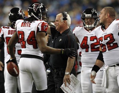 Atlanta Falcons head coach Mike Smith (C ) congratulates wide receiver Roddy White (L ) after his touchdown against the Detroit Lions during Atlanta Falcons head coach Mike Smith (C ) congratulates wide receiver Roddy White (L ) after his touchdown against the Detroit Lions during