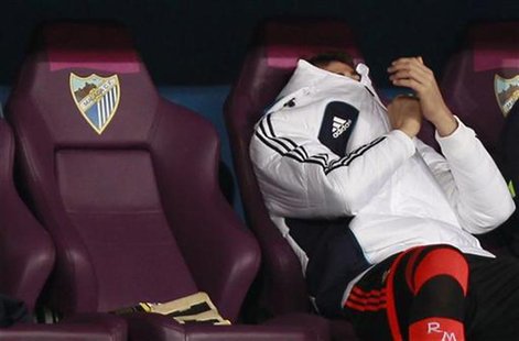 Real Madrid's goalkeeper Iker Casillas sits in the bench during their Spanish First Division soccer match against Malaga at La Rosaleda stad Real Madrid's goalkeeper Iker Casillas sits in the bench during their Spanish First Division soccer match against Malaga at La Rosaleda stad