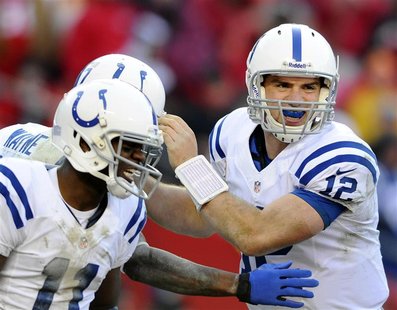Indianapolis Colts quarterback Andrew Luck (R) and wide receiver Donnie Avery (L) congratulate wide receiver Reggie Wayne on his go-ahead to Indianapolis Colts quarterback Andrew Luck (R) and wide receiver Donnie Avery (L) congratulate wide receiver Reggie Wayne on his go-ahead to